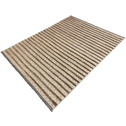 Rug with a ribbed stripe pattern in beige and brown, square-like appearance, edge visible