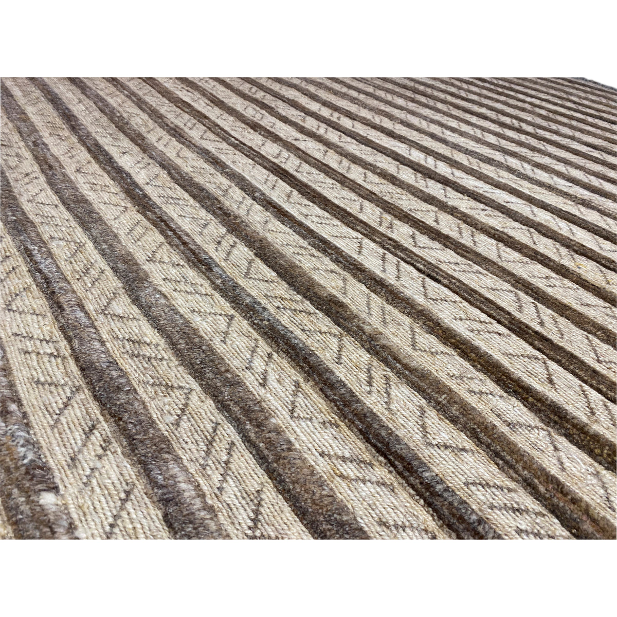 Close-up: woven strips in beige and brown, textured surface of the rug