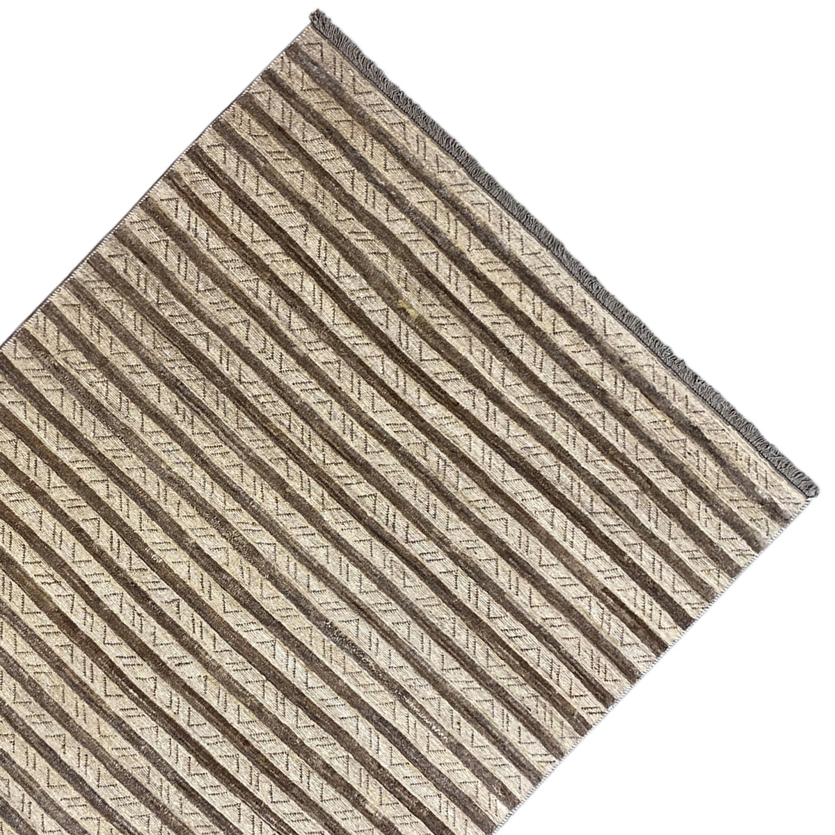Rug viewed at an angle: even stripes in beige and brown, with a bound edge