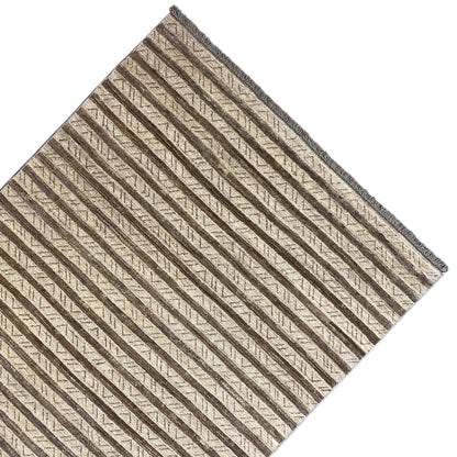 Rug viewed at an angle: even stripes in beige and brown, with a bound edge