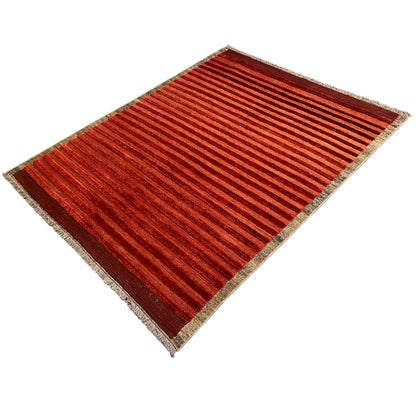 Carpet in angled view with a red striped pattern and bound edge