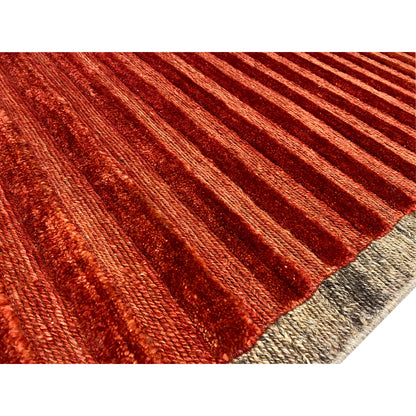 Close-up of carpet: reddish-brown striped pattern with a fine, heathered texture