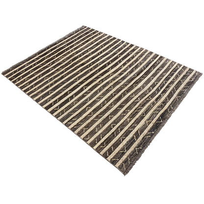Rug in a diamond pattern with brown-black stripes and triangular details, with fringes