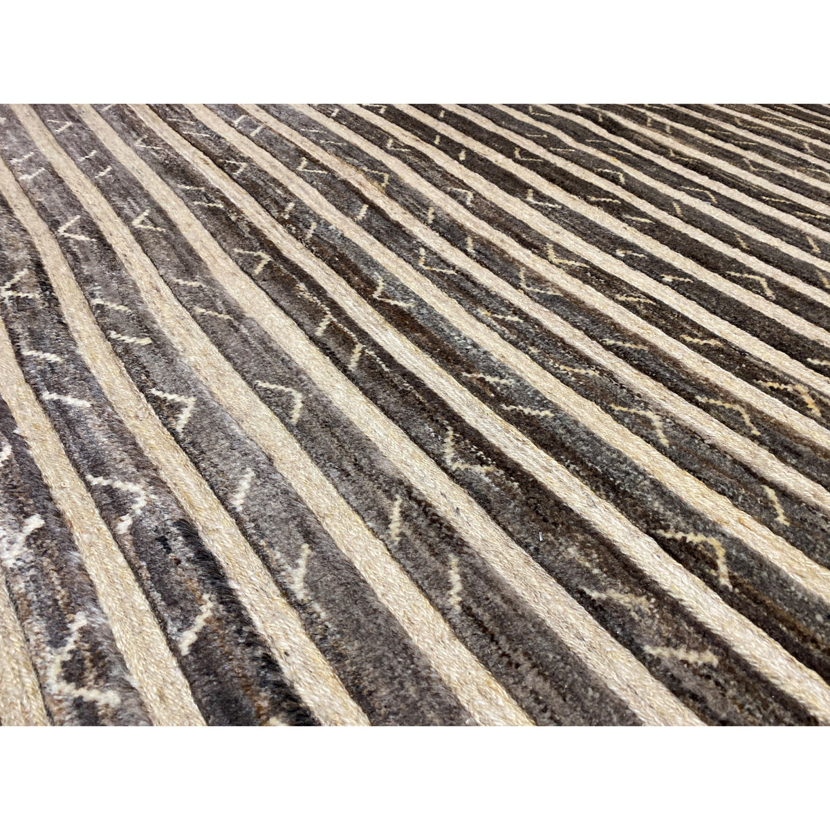 Detail view: rug with diagonal stripes and contrasting triangles