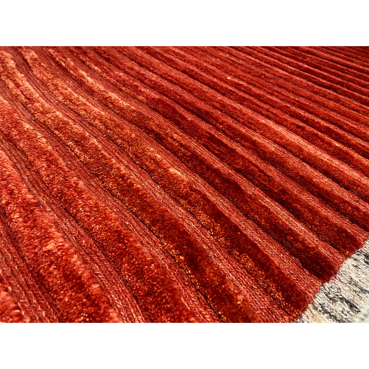 Close-up: red carpet with fine stripes and textured pile