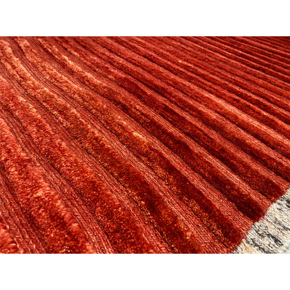 Close-up: red carpet with fine stripes and textured pile