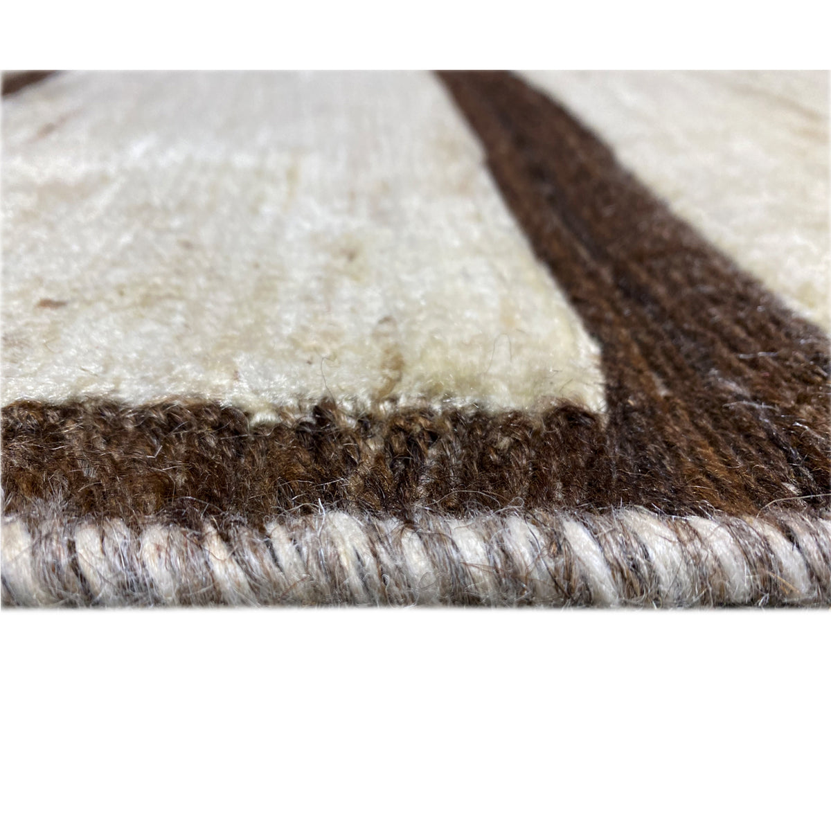 Close-up of the Nimbaft rug: multicolored pile fibers along the edge