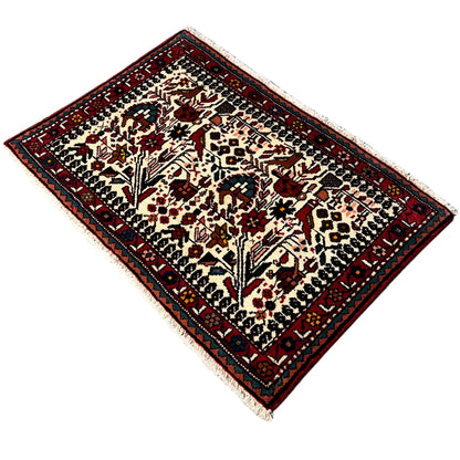 Poshti rug in oblique view, delicate ornamental design with a dark red border