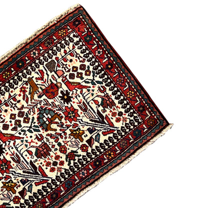 Poshti rug detail view, dense pile with colorful motifs and borders