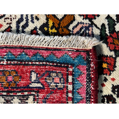 Poshti rug edge detail with fringed edging and multicolored border