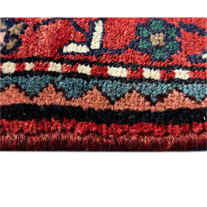 Poshti rug detail with pile height and fringed edge, shades of red and blue