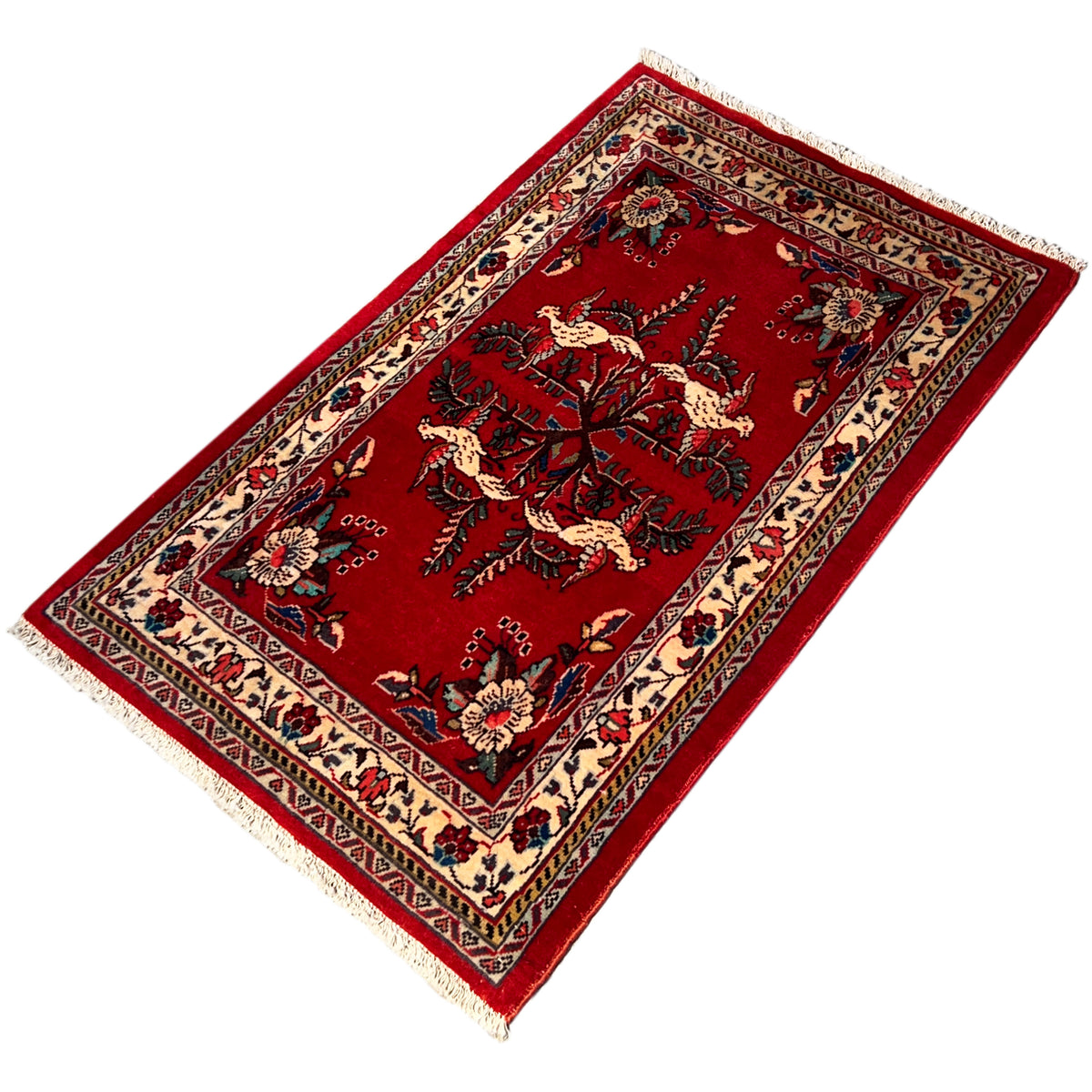 Red carpet at an angle with a medallion motif, border and fringes along the edge