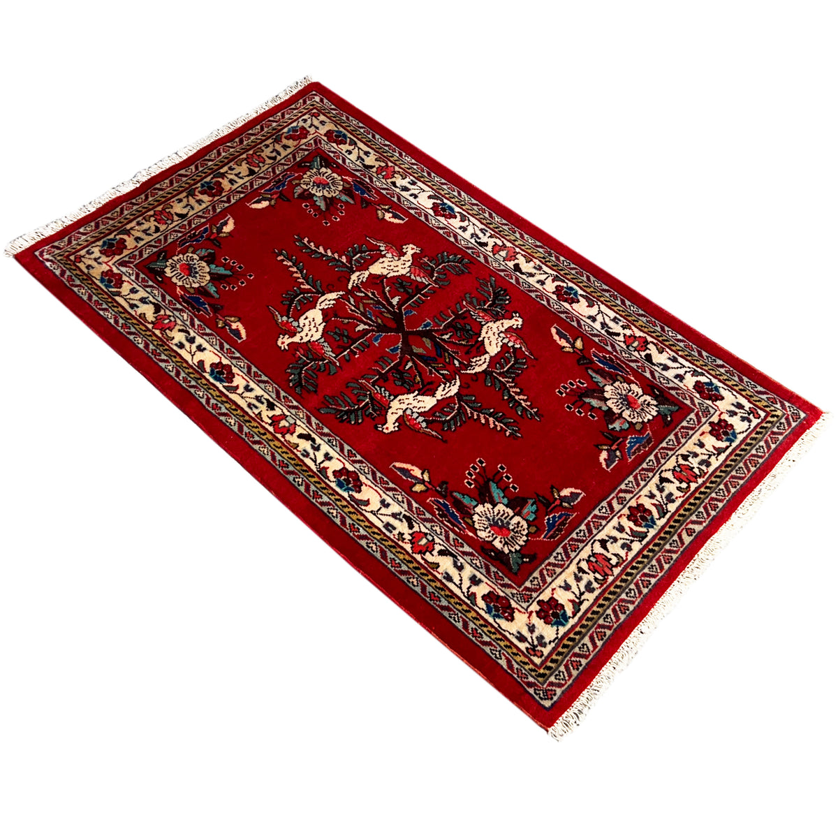 Red carpet with a central tree and animal motif, ornaments in cream, blue, and green