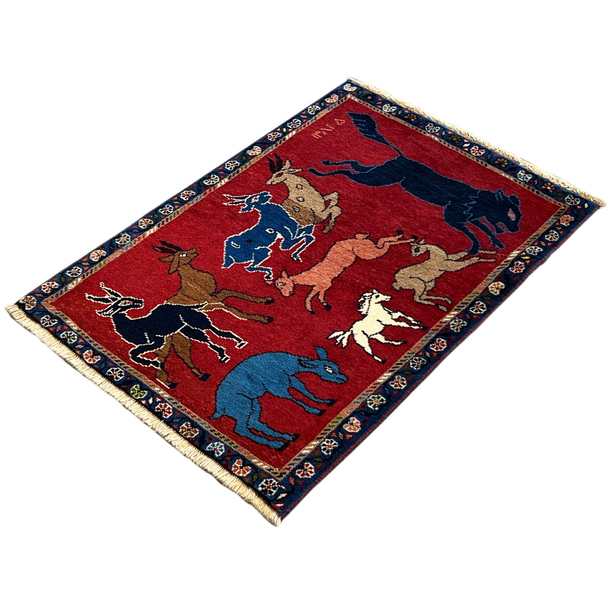 Wool rug, rectangular: red field with colorful animal figures, dark blue border