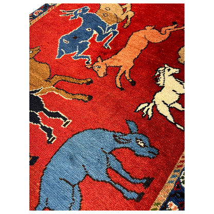 Wool rug with a red pattern and blue animal motifs, rectangular, bordered