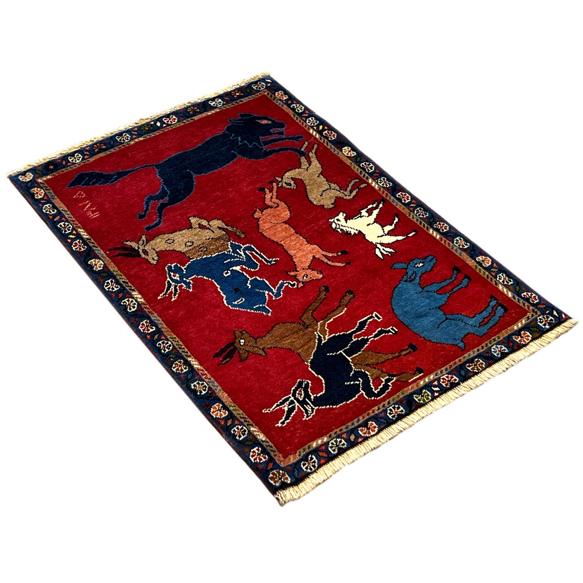 Rectangular wool rug with red areas and animal motifs, dark blue border