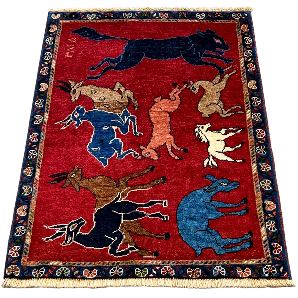 Wool rug with a red background, many animal depictions, framed in blue