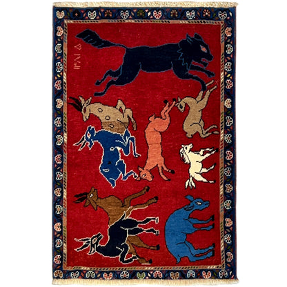 Wool rug with a red background, animal motifs, and a dark blue border, rectangular