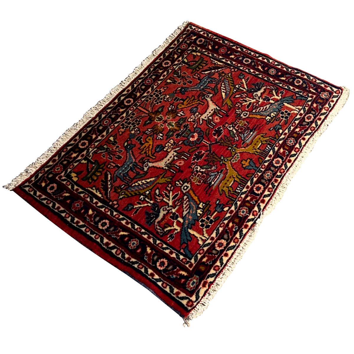 Red Poshti rug, angled, with a detailed pattern and bound edges