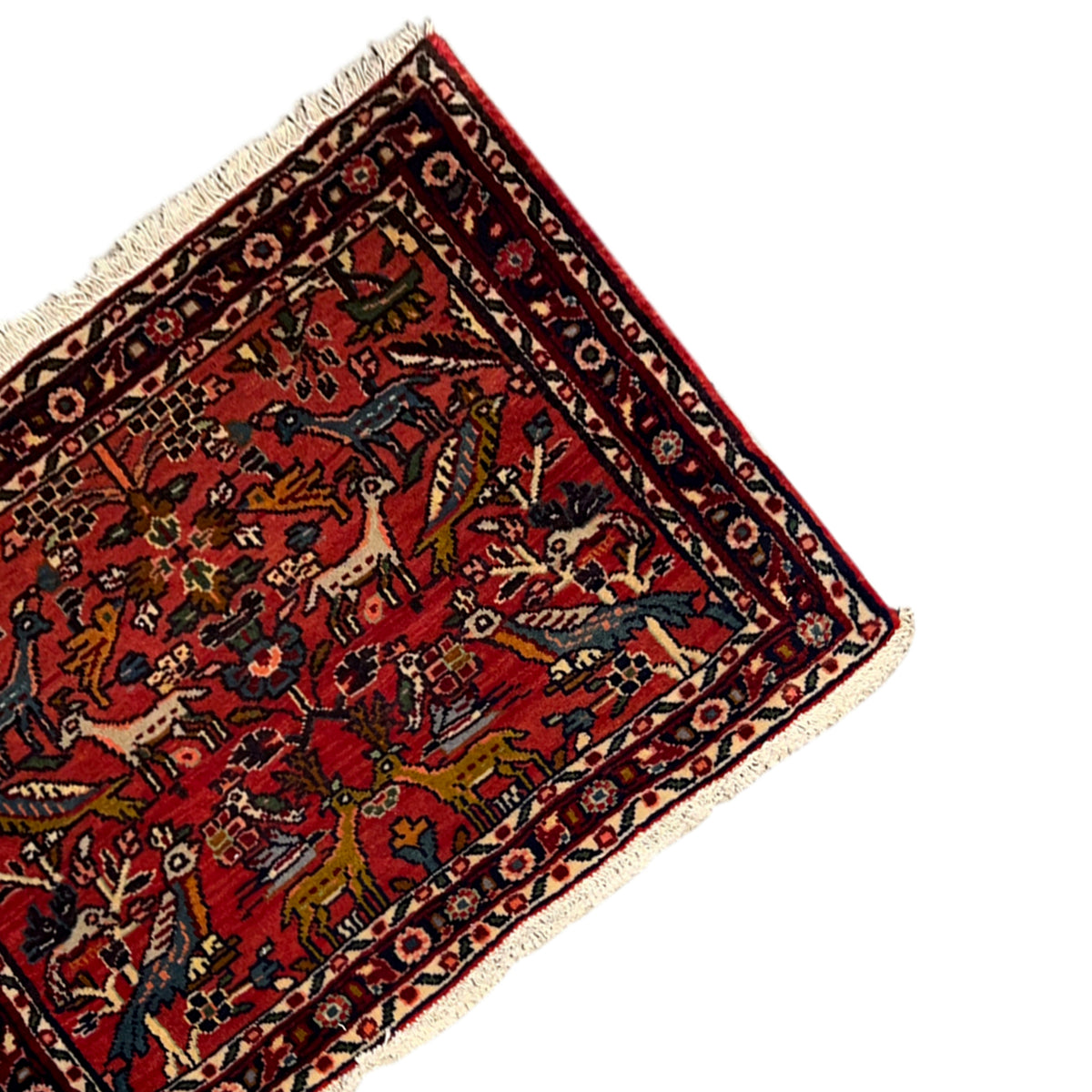 Red Poshti rug in detail with colorful figure motifs and a black border line