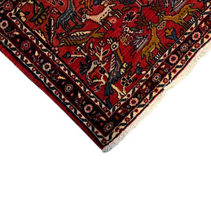 Red Poshti rug corner with multicolored pattern, border stripe, and bound edge