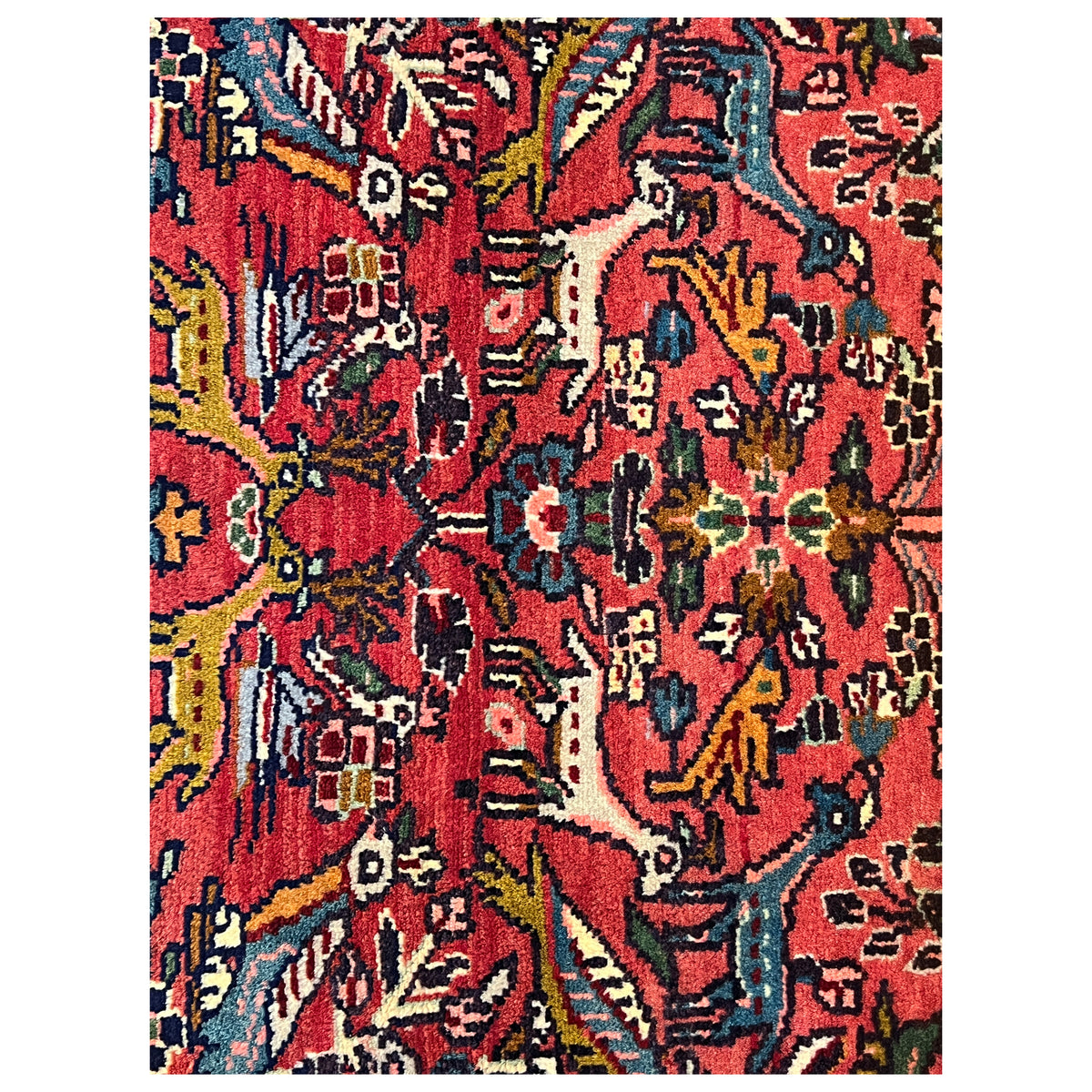 Red Poshti rug with dense ornamental details in blue, yellow, green, and white