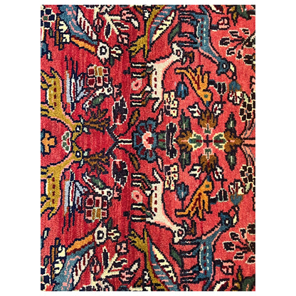 Red Poshti rug with dense ornamental details in blue, yellow, green, and white