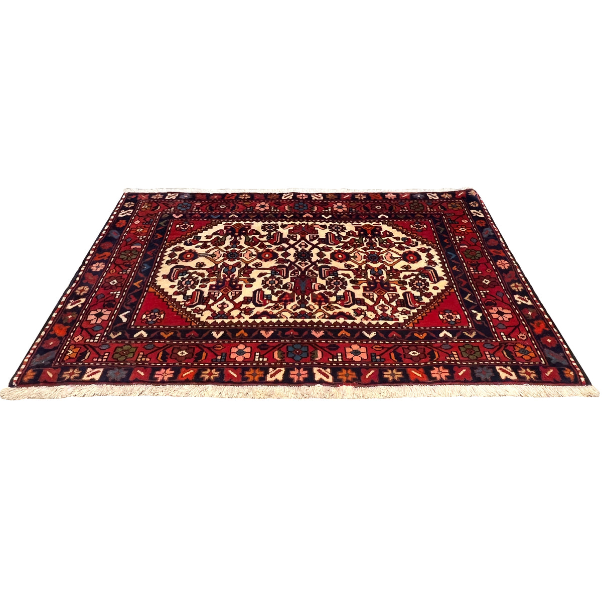 Rectangular red rug with a delicate pattern, dark borders, and light fringes