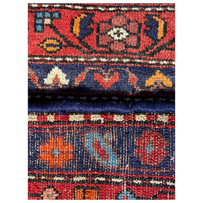 Close-up of trim with colorful ornaments and a blue border, including fringes