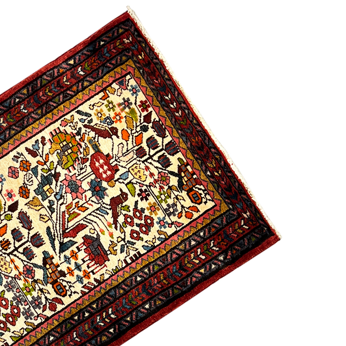 Close-up of the edge of the Poshti rug: red decorative band with ornaments on cream