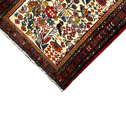Corner of the Poshti rug with a colorful pattern and multicolored border trim