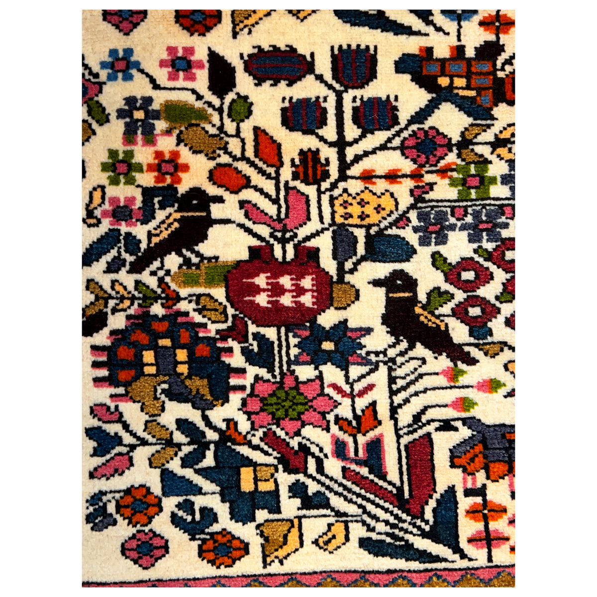 Close-up of the Poshti rug pattern: many ornaments in cream, red, blue, and yellow