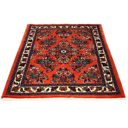 Rectangular rug with an orange design and dark blue border pattern