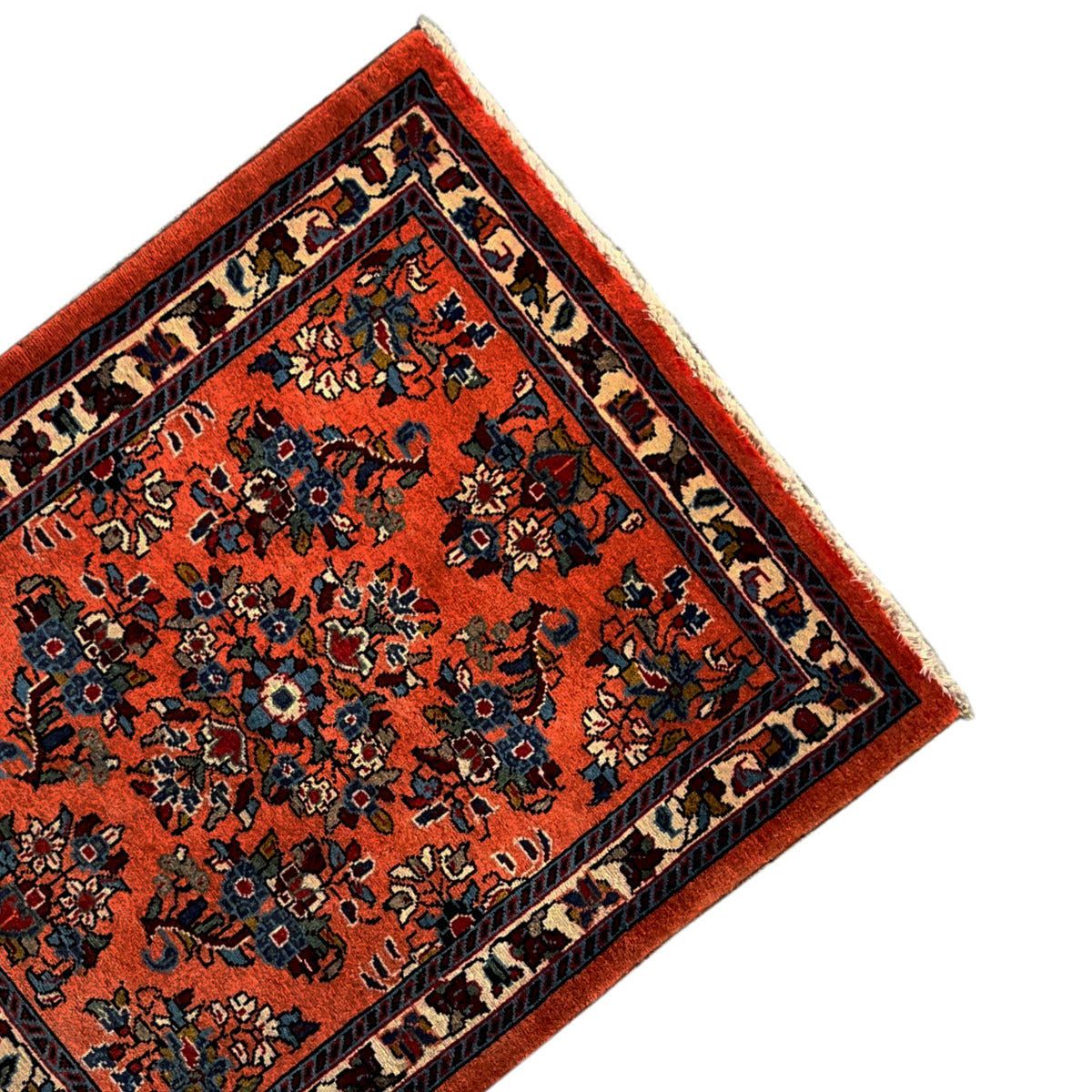Carpet detail: orange base with blue-black ornaments and a narrow border