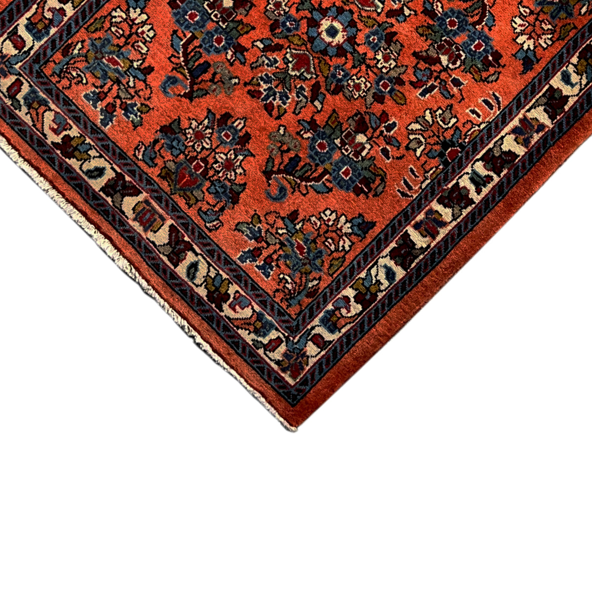 Carpet detail in orange and blue with a decorative frame, edges visible
