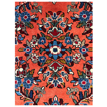 Carpet-like view: orange background with colorful floral motifs and blue-and-white accents