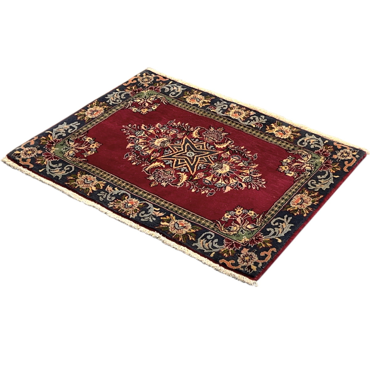 Rectangular rug with a red central medallion and blue decorative border, with fringes