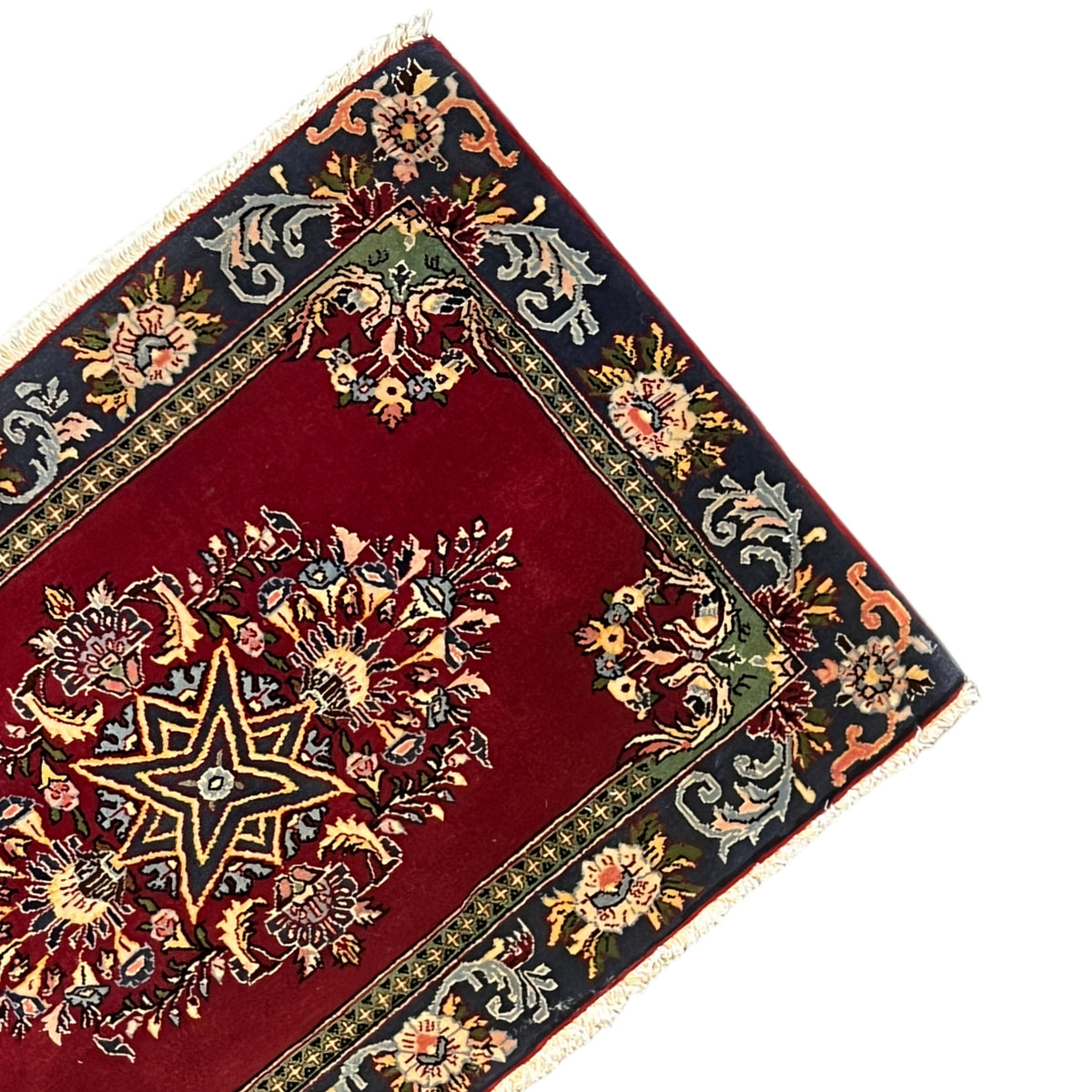 Carpet corner with a red field, gold and blue ornaments, fringe trim