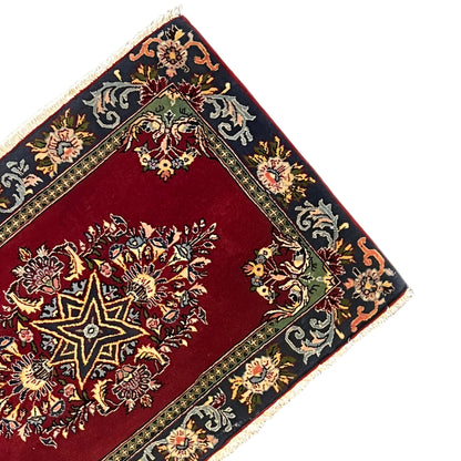 Carpet corner with a red field, gold and blue ornaments, fringe trim