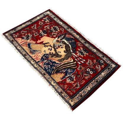 Red patterned rug shown from a diagonal angle with fringes along the edges