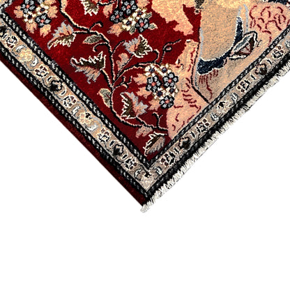 Close-up of the edge: red carpet with dark trim and fringe