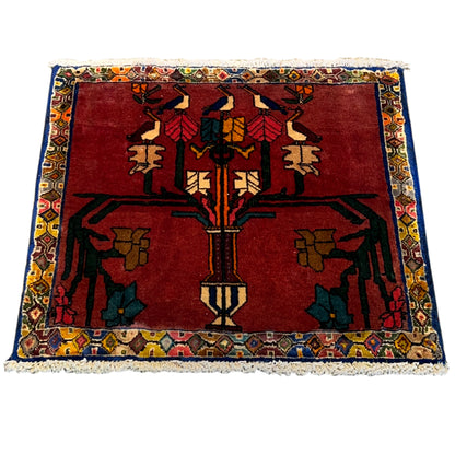 Rug with a red base and blue border, oriental pattern with a central medallion, fringe