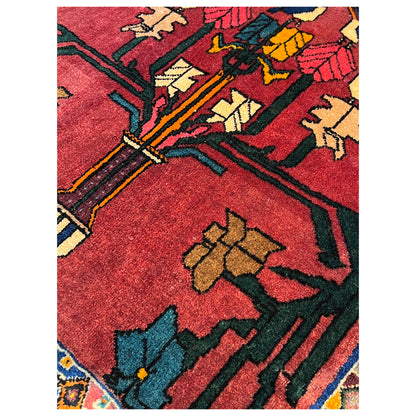 Close-up: red carpet with multicolored ornaments and chain lines, intricate patterns