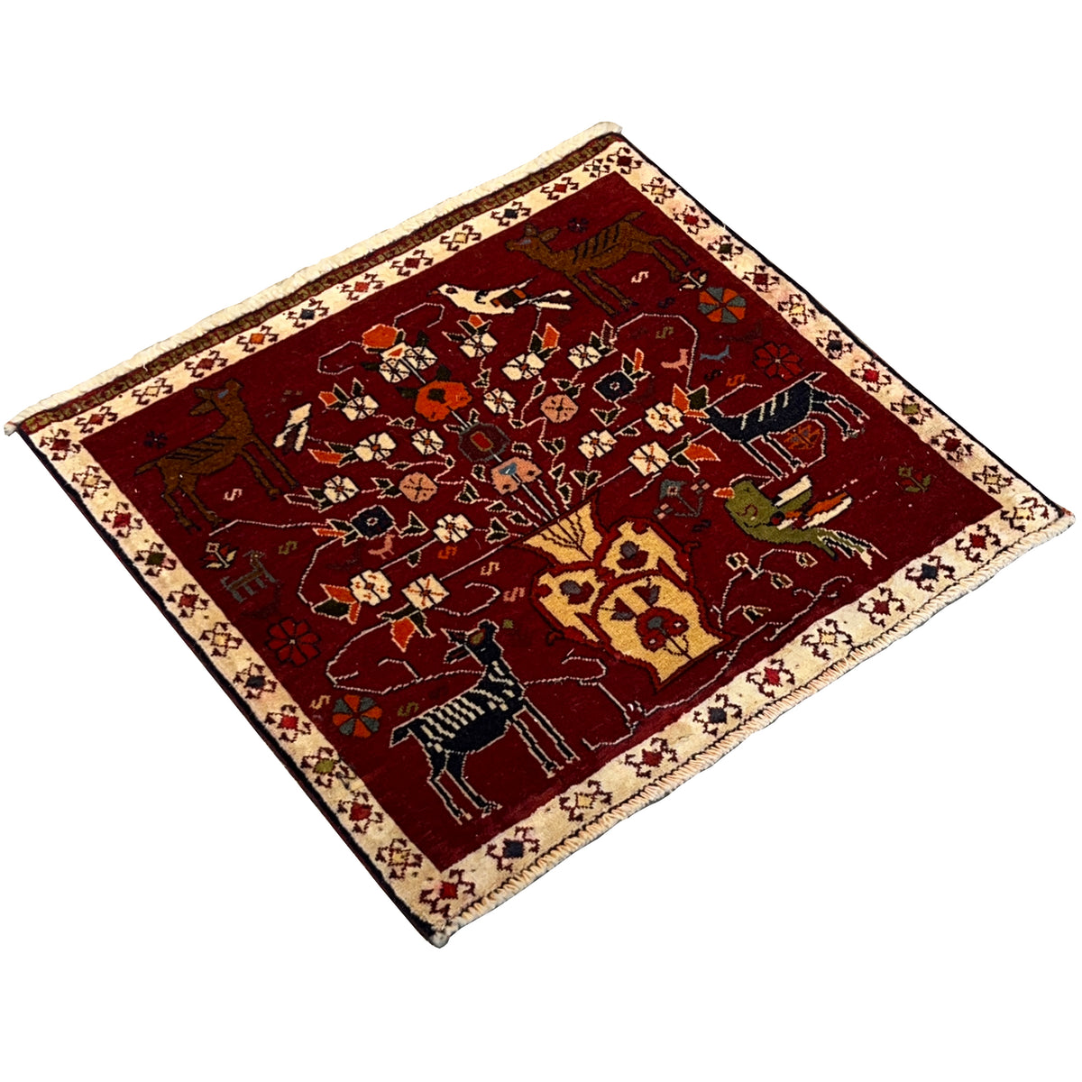 Red Poshti rug viewed diagonally with colorful animal and floral motifs, border
