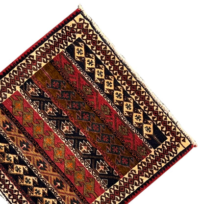 Multicolored Poshti rug with a diamond and stripe pattern and a detailed border