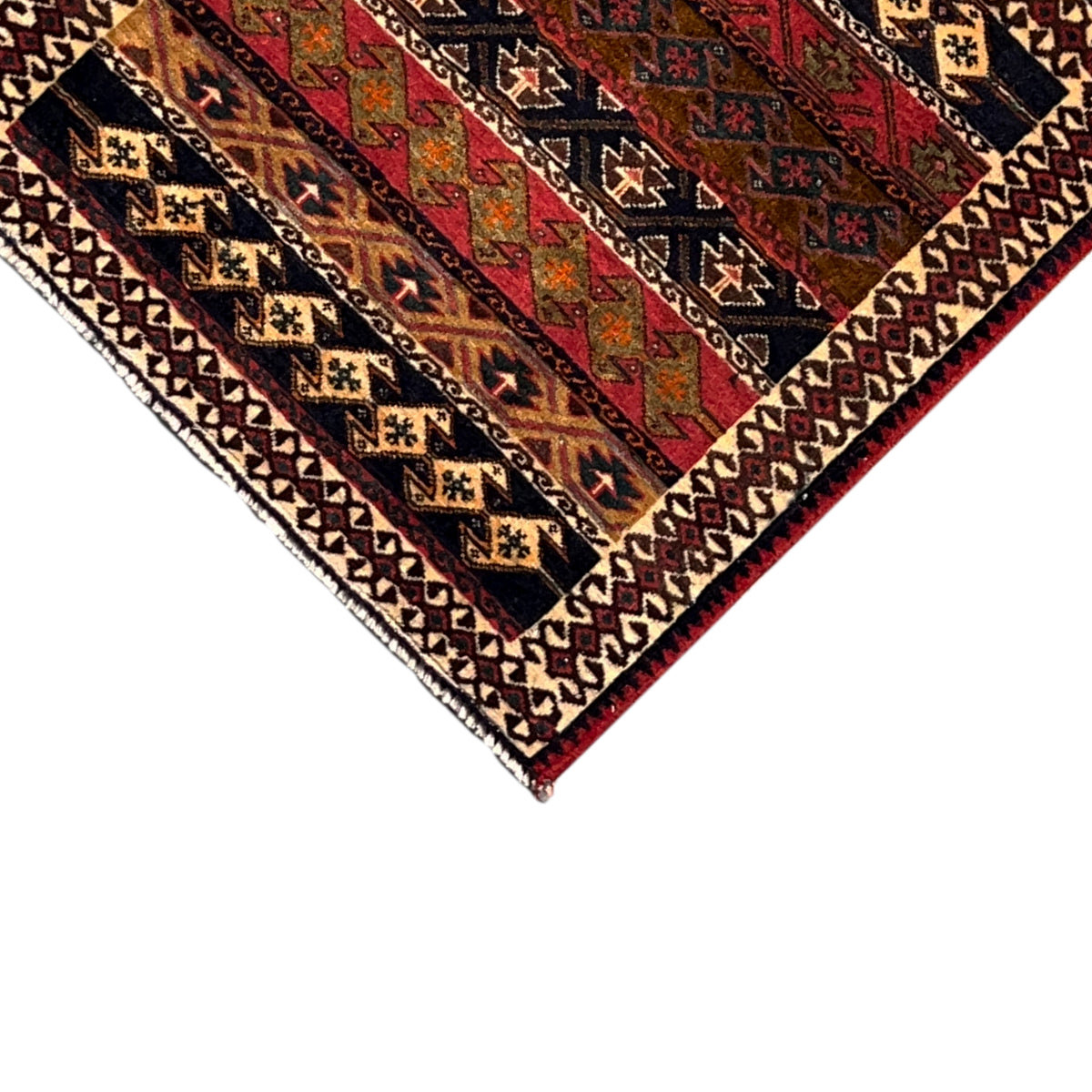 Corner of the colorful Poshti rug with geometric motifs and a hemmed border