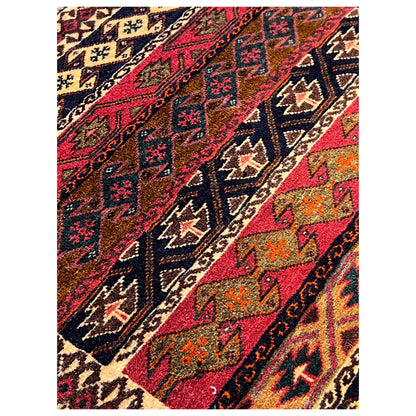 Close-up of the Poshti rug with a colorful geometric pattern field