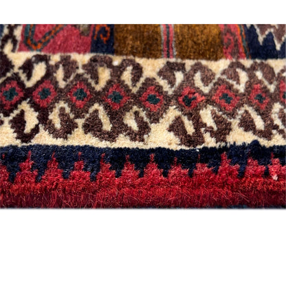 Close-up of the carpet edge with fringes in red and a cream-colored patterned stripe