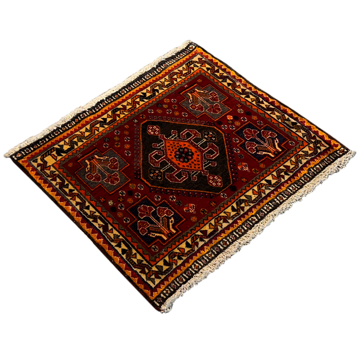 Rug with a red central field, black and orange patterns, and beige fringe