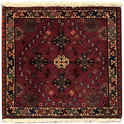 Red Poshti rug with ornaments, multicolored border and fringes, 55x56 cm